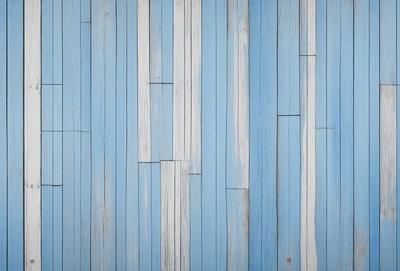 The primary subject of the image is a blue and white wooden wall. The setting is a room with a blue and white wooden floor. The visual style is a photo of a wooden wall. The dominant colors are blue and white, creating a calm and soothing atmosphere.