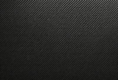 The primary subject of the image is a black background with a pattern of white stripes. The setting is a dark room, and the visual style is a black and white photo. The dominant colors are black and white, creating a moody atmosphere.