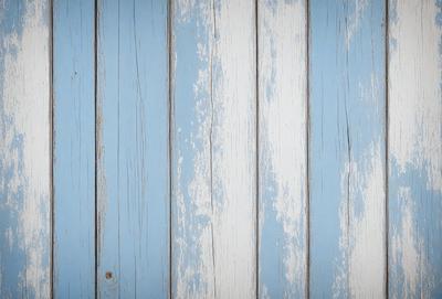 The primary subject of the image is a blue wall with white stripes. The setting is a room with a blue wall, and the visual style is a photo. The dominant colors are blue and white, creating a calm and soothing atmosphere.