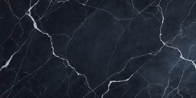 The primary subject of the image is a black marble countertop. The setting is a dark room, and the visual style is a close-up of the marble countertop. The countertop appears to be a dark grey color, giving it a sophisticated and elegant appearance.