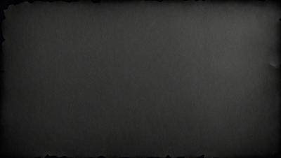 The primary subject of the image is a black background. The setting is a dark room, and the visual style is a black and white photo. The colors and mood are dark and moody, creating a dramatic atmosphere.