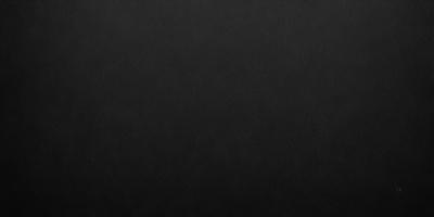 The primary subject of the image is a black background. The setting is a dark room, and the visual style is a black and white photo. The colors and mood of the image are dark and moody, creating a sense of mystery or drama.