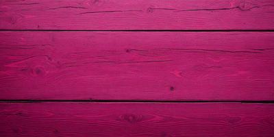 The primary subject of the image is a wooden wall with a pinkish hue. The setting is a room with a wooden surface, and the visual style appears to be a photo. The dominant colors in the image are pink and brown, creating a warm and inviting atmosphere.