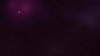The image is a purple sky with a few stars visible. The sky is dark and void of any other objects or details. The overall atmosphere is calm and serene.