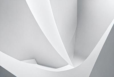 The primary subject of the image is a white paper, which is the main object, scene, or focus of the image. The setting is a white background, and the visual style is a photo. The colors and mood of the image are predominantly white, giving it a clean and minimalist appearance.