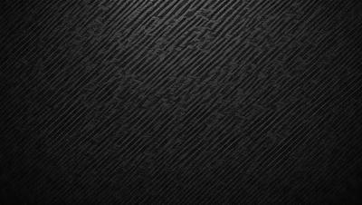 The primary subject of the image is a black and white patterned background. The setting is a dark background, which contrasts with the patterned design. The visual style is a combination of a photo and a pattern, creating a unique and intriguing appearance. The colors and mood of the image are predominantly dark and moody, with the black and white pattern adding a sense of depth and contrast.