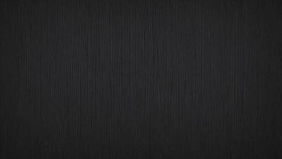 The primary subject of the image is a wooden wall. The setting is a dark room, and the visual style is a black and white photo. The colors and mood of the image are predominantly dark and moody, with the wooden wall serving as the focal point.