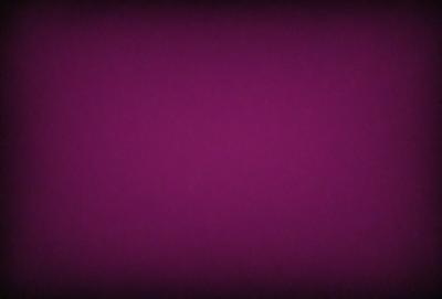 The primary subject of the image is a purple background. The setting is a dark, purple room, and the visual style is a close-up of the purple wall. The colors and mood of the image are predominantly purple, creating a calm and serene atmosphere.
