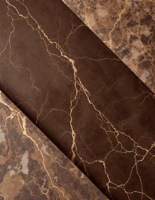 The primary subject of the image is a brown leather material, which appears to be a piece of leather or a leather-like fabric. The setting is a marbled surface, which adds a sense of sophistication and elegance to the scene. The visual style of the image is a close-up of the leather material, showcasing its texture and details. The colors in the image are predominantly brown, which creates a warm and earthy atmosphere.