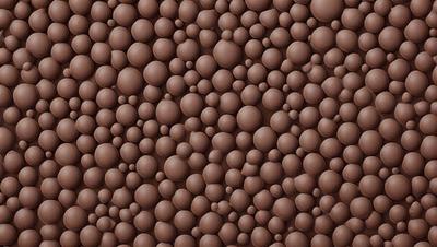 The primary subject of the image is a wall covered in a pattern of chocolate-colored balls. The setting is a room with a brown wall, and the visual style appears to be a close-up of the wall, showcasing the intricate pattern of the balls. The colors and mood of the image are predominantly brown, giving it a warm and cozy atmosphere.