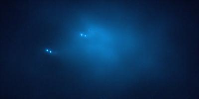 The primary subject of the image is a blue sky with a few stars visible. The setting is a night sky, and the visual style appears to be a photo. The colors and mood of the image are predominantly blue, creating a serene and peaceful atmosphere.