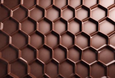 The primary subject of the image is a close-up of a chocolate-covered surface, possibly a chocolate wall or a chocolate-patterned wallpaper. The setting is indoors, with the chocolate surface being the main focus of the image. The visual style appears to be a close-up of a textured surface, possibly a wallpaper or a wall, with the chocolate pattern being the main element. The colors and mood of the image are predominantly brown and rich,