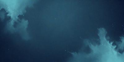 The primary subject of the image is a night sky filled with stars. The setting is a dark, cloudy night, with the stars shining brightly against the black background. The visual style is a photo of the night sky, capturing the beauty of the stars and the vastness of the night. The colors and mood of the image are predominantly dark and moody, with the stars providing a touch of brightness and wonder.