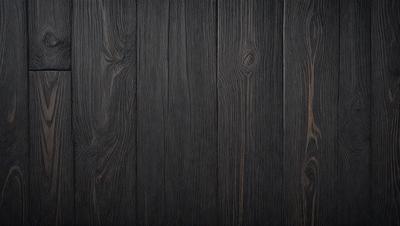 The primary subject of the image is a wooden floor. The setting is a room with a wooden floor, and the visual style is a photo. The colors and mood of the image are predominantly dark, with the wooden floor being the main focus.