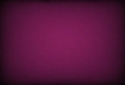 The primary subject of the image is a purple background. The setting is a dark room, and the visual style appears to be a photo. The dominant colors are purple and black, creating a moody atmosphere.
