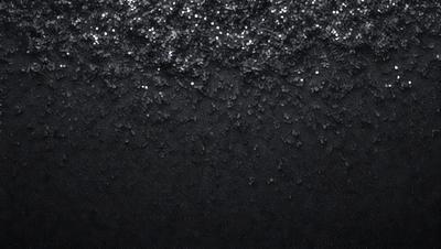 The primary subject of the image is a black background with a pattern of glittering stars. The setting is a dark, starry night, and the visual style is a combination of a photo and digital art. The colors and mood are predominantly dark and mysterious, with the glittering stars adding a touch of brightness and intrigue to the scene.