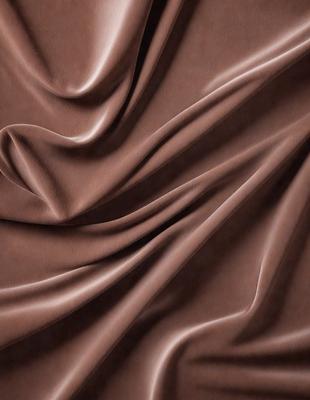 The primary subject of the image is a brown fabric, possibly a piece of velvet, with a rich texture. The setting is a close-up view of the fabric, showcasing its intricate details. The visual style is a detailed, up-close representation of the fabric, emphasizing its unique texture and appearance. The colors and mood of the image are warm and inviting, with the brown fabric serving as the main focus.