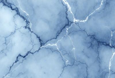The primary subject of the image is a blue marble surface with a pattern of lightning bolts. The setting is a blue sky, and the visual style is a photo. The dominant colors are blue and white, creating a calm and serene atmosphere.
