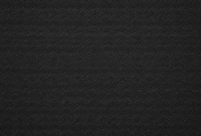 The primary subject of the image is a black and white patterned fabric. The setting is a black background, and the visual style is a patterned fabric. The colors and mood of the image are predominantly black and white, creating a classic and timeless appearance.