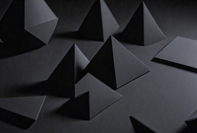 The primary subject of the image is a collection of black triangles, which are arranged in various orientations and sizes. The setting is a black background, which contrasts with the triangles, making them stand out. The visual style is a combination of digital art and illustration, as the triangles are created using a pattern or texture. The overall atmosphere is dark and mysterious, with the black triangles serving as the main focus of the image.