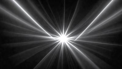 The primary subject of the image is a bright light source, possibly a light bulb or a star, with a white and yellow hue. The light source is surrounded by a black background, which creates a striking contrast. The visual style of the image is a close-up of the light source, emphasizing its brightness and intensity. The colors and mood of the image are energetic and captivating, as the light source stands out against the dark background.