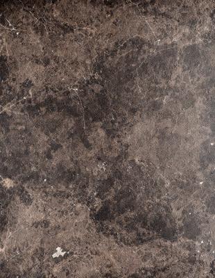 The image features a marble-like surface with a brown and black color scheme. The primary subject is a close-up of the marble, showcasing its texture and pattern. The setting is a room with a brown and black marble floor, which adds to the overall atmosphere of the space. The visual style is a close-up of the marble, emphasizing its unique texture and pattern.