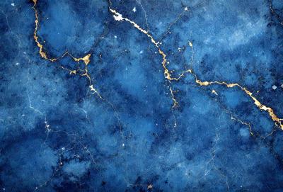 The primary subject of the image is a blue marble wall with gold veins. The setting is a room with a blue marble wall as the main focus. The visual style is a close-up of the marble wall, showcasing its unique texture and design. The dominant colors are blue and gold, creating a sense of luxury and elegance.