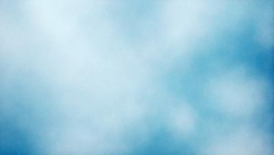 The primary subject of the image is a cloudy blue sky. The setting is a vast expanse of the sky, with no visible land or other objects. The visual style is a natural, outdoor scene, and the colors and mood are serene and peaceful.