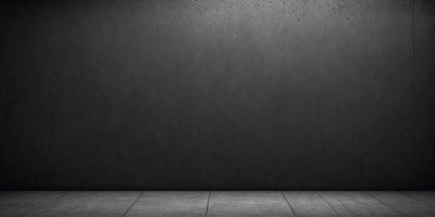 The primary subject of the image is a large, gray wall. The setting is a room with a concrete floor. The visual style is a black and white photo. The dominant colors are gray and black, creating a moody atmosphere.