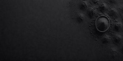 The primary subject of the image is a black background with a few white specks. The setting is a dark room, and the visual style is a close-up of the black background. The colors and mood of the image are predominantly dark and moody, with the white specks adding a touch of contrast.
