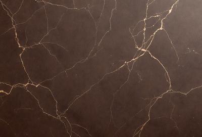 The primary subject of the image is a brown marble wall with a leather-like texture. The setting is a room with a brown leather wallpaper, which adds to the overall atmosphere. The visual style is a close-up of the wallpaper, showcasing the intricate details of the marble pattern. The colors and mood of the image are warm and inviting, with the brown leather wallpaper and marble pattern creating a cozy and luxurious ambiance.