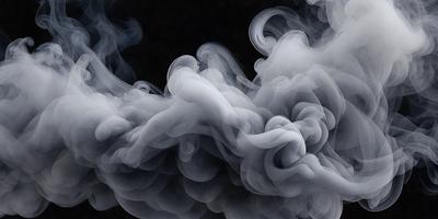 The primary subject of the image is a large, swirling cloud of smoke. The setting is a dark background, which contrasts with the smoke, making it the focal point of the image. The visual style is a black and white photo, which adds a dramatic and artistic touch to the scene. The colors and mood of the image are predominantly dark and moody, with the smoke creating a sense of mystery and intrigue.