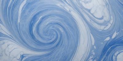 The primary subject of the image is a blue spiral pattern, which is the main object, scene, or focus of the image. The setting or background is a white surface, which provides a clean and uncluttered backdrop for the spiral pattern. The visual style of the image is a combination of digital art and illustration, as it appears to be a digital artwork or illustration of a spiral pattern. The dominant colors in the image are blue and white, creating a calm and soothing atmosphere.