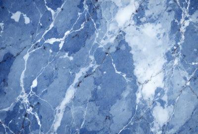 The primary subject of the image is a blue marble wall with a pattern of white and blue swirls. The setting is a room with a blue marble floor. The visual style is a close-up of the marble wall, showcasing the intricate pattern. The colors and mood of the image are predominantly blue, creating a calm and serene atmosphere.