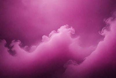The primary subject of the image is a pink cloud, which is the main focus of the scene. The setting is a cloudy sky, and the visual style appears to be a photo. The dominant colors in the image are pink and purple, creating a warm and serene atmosphere.