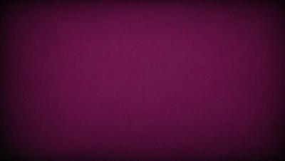 The primary subject of the image is a purple background. The setting is a dark, purple room. The visual style is a close-up of the purple background, which creates a moody and dramatic atmosphere.