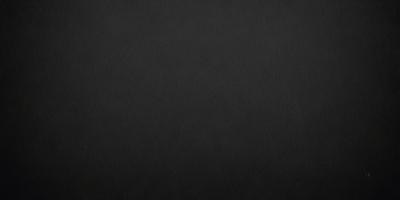 The primary subject of the image is a black background. The setting is a dark room, and the visual style is a black and white photo. The colors and mood of the image are dark and moody, creating a sense of mystery or drama.
