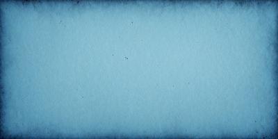 The primary subject of the image is a blue background with a few white specks. The setting is a blue paper, and the visual style is a close-up of the paper. The colors and mood of the image are predominantly blue, with a few white specks adding a touch of contrast.