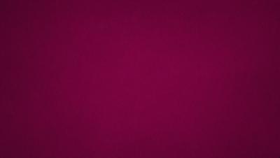 The primary subject of the image is a large, purple wall. The setting is a room with a purple background, which creates a unique and striking visual effect. The visual style of the image is a close-up of the purple wall, emphasizing its color and texture. The dominant colors in the image are purple and red, giving the scene a bold and vibrant atmosphere.