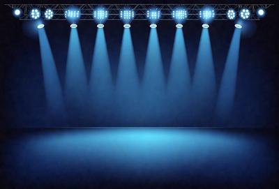 The primary subject of the image is a stage with a blue background and a row of bright lights shining on it. The stage appears to be empty, with no performers or objects visible. The setting is a theater or a performance venue, and the visual style is a realistic representation of the stage and lights. The colors and mood of the image are predominantly blue, creating a calm and serene atmosphere.