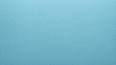 The primary subject of the image is a large, empty blue sky. The setting is a vast, open space with no visible landmarks or objects. The visual style is a realistic representation of the sky, with no indication of digital art or illustration. The colors and mood of the image are predominantly blue, creating a calm and serene atmosphere.