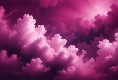 The primary subject of the image is a cloudy sky with pink clouds. The setting is a purple cloudy sky, and the visual style is a photo. The colors and mood of the image are predominantly pink, creating a warm and serene atmosphere.