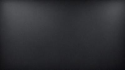 The image is a black and white photo of a blank canvas. The primary subject is the canvas, which is the main object, scene, or focus of the image. The setting/background is a black background, which provides a stark contrast to the canvas. The visual style is a black and white photo, which gives the image a classic and timeless appearance. The colors and mood are predominantly black, which creates a sense of simplicity and elegance.