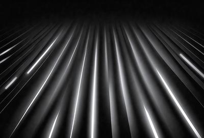The primary subject of the image is a long, thin, and bright light source. The light appears to be a long, thin, and bright light source. The light source is illuminating a dark background, creating a striking contrast. The setting is a black background, which emphasizes the brightness of the light source. The visual style of the image is a close-up of the light source, showcasing its unique and striking appearance. The colors and mood of the image are predominantly dark and dramatic, with the