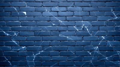 The primary subject of the image is a blue brick wall with white streaks. The setting is a brick wall, and the visual style is a photo. The dominant colors are blue and white, creating a calm and serene atmosphere.