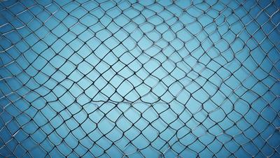 The primary subject of the image is a close-up of a metal mesh, which appears to be a patterned metal fabric. The setting is a blue background, which complements the metal mesh. The visual style is a close-up of the metal mesh, showcasing its intricate pattern. The colors and mood of the image are predominantly blue, giving it a calm and serene atmosphere.