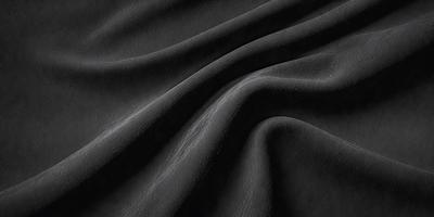 The primary subject of the image is a black fabric, which appears to be a piece of cloth or a curtain. The setting is a dark room, and the visual style is a close-up of the fabric. The colors and mood of the image are predominantly dark and moody, with the black fabric being the main focus.