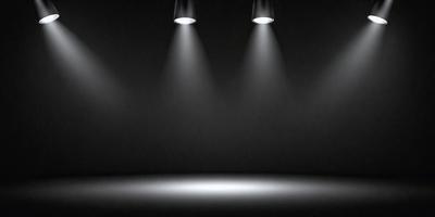 The primary subject of the image is a black background with three lights shining on it. The lights are positioned at different angles, creating a visually striking scene. The setting is a dark room, and the visual style appears to be a combination of a photo and digital art. The colors and mood of the image are predominantly dark, with the lights providing a contrasting element.