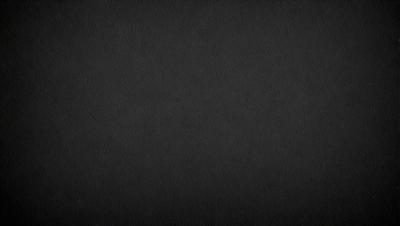 The primary subject of the image is a black background. The setting is a dark, empty space with no visible objects or elements. The visual style is a black and white photo, which gives the image a classic and timeless appearance. The colors and mood are predominantly dark and moody, creating a sense of mystery and depth.