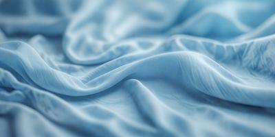 The primary subject of the image is a blue sheet or blanket. The setting is a bed, and the visual style is a close-up of the sheet. The colors and mood of the image are predominantly blue, creating a calm and soothing atmosphere.